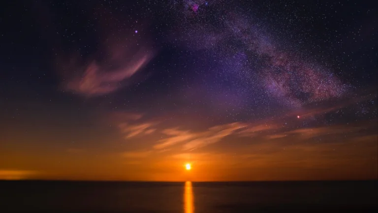 The Milky Way above the horizon, bathed in the rays of the rising sun