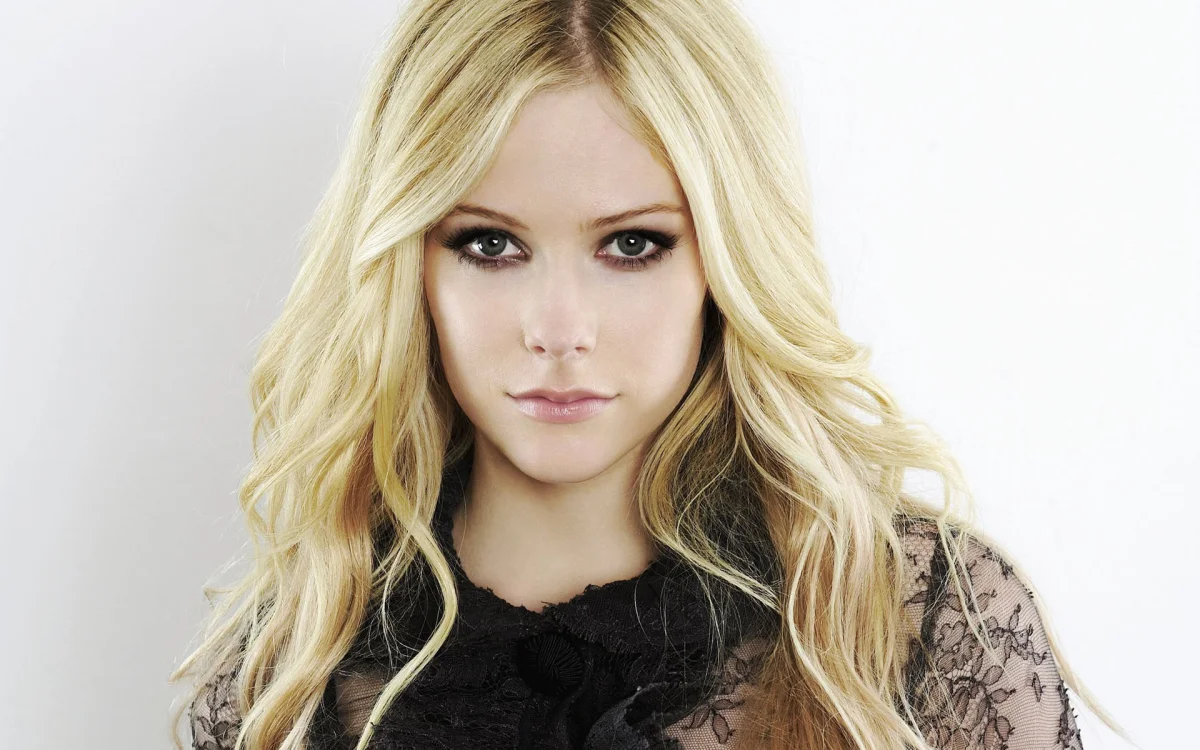 A portrait of Avril Lavigne against a light background