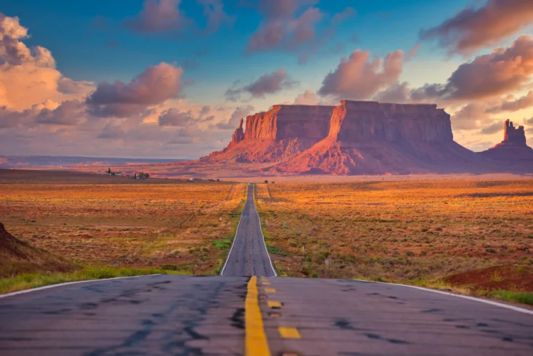 The highway stretching off into the distance toward the cliffs of the Valley of Monuments