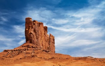 The red cliffs of the Valley of Monuments under a bright daytime sky