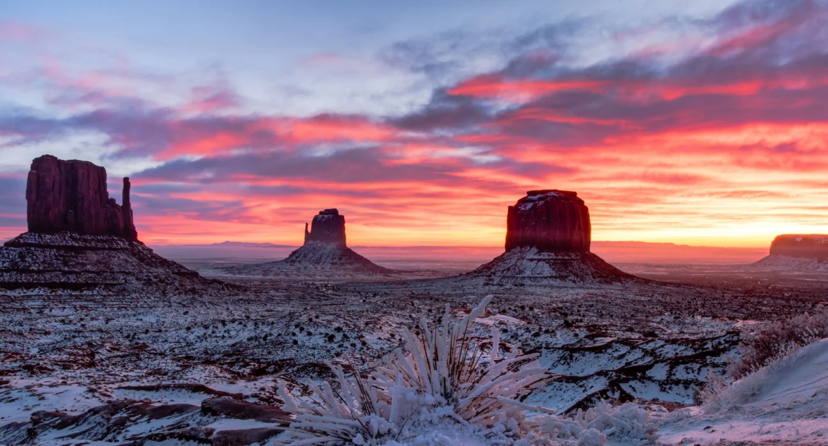 A pink sunset over the snow-covered cliffs of the Valley of the Monuments in the United States