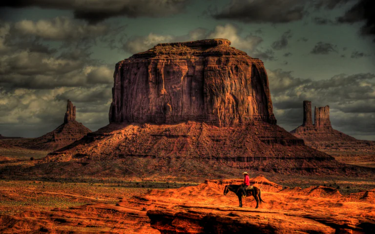 A lone rider in the Valley of Monuments under a stormy sky
