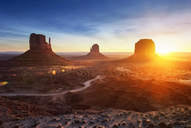 Golden rays of sunlight over the cliffs of the Valley of Monuments in the U.S.