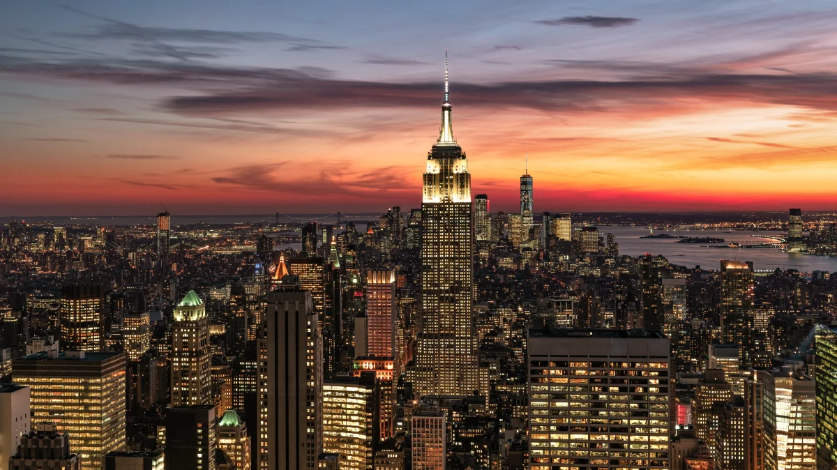 the empire state building bathed in the glow of the sunset sky over new york city, cities, city, cityscape, cityscapes, megacities, new york, night lights, lights, streetlights, street lamps, lighting, night, skyscrapers, sunsets, sunset, usa, united states, architecture