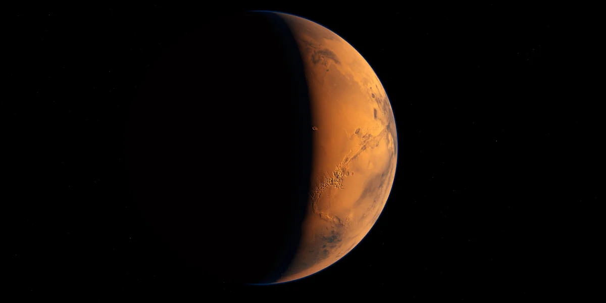 A crescent of Mars illuminated by the sun in the deep darkness