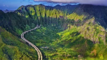 The winding H-3 highway among the green slopes of the Ko'olau Mountains in Hawaii