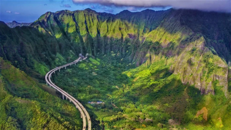 The winding H-3 highway among the green slopes of the Ko'olau Mountains in Hawaii