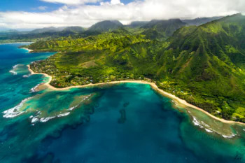 The green mountain slopes and turquoise waters of the Kauai coastline