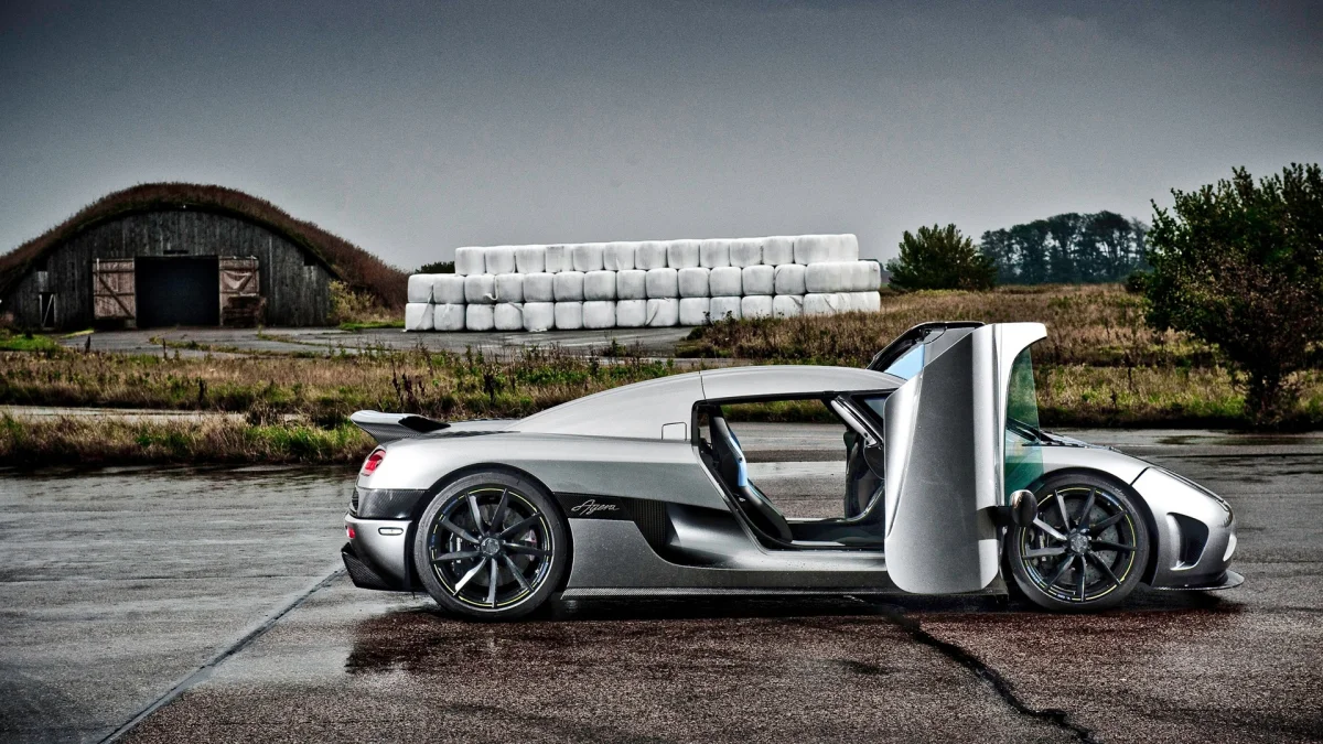 A silver Koenigsegg Agera against the backdrop of a Swedish field