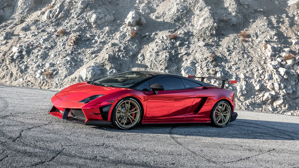 A red Lamborghini Gallardo against the backdrop of a rocky mountainside