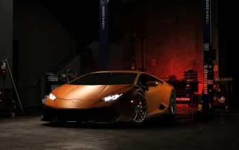 An orange Lamborghini Huracán in the dim light of the repair bay