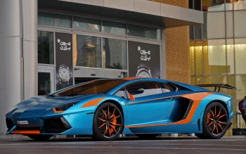 A bright blue Lamborghini Aventador with orange accents