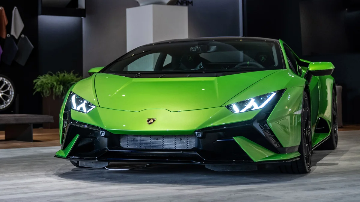 A bright green Lamborghini Huracán in the showroom