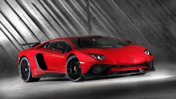 A red Lamborghini Aventador SV in the light of the studio spotlights