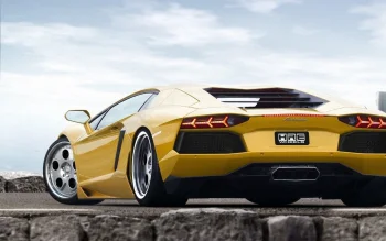 A yellow Lamborghini Aventador against a cloudy sky