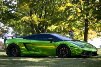 A bright green Lamborghini Gallardo against a backdrop of fall foliage