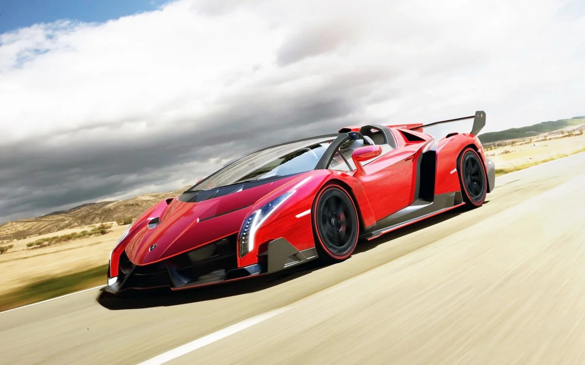 A red Lamborghini Veneno Roadster on the highway