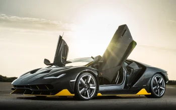 A Lamborghini Centenario with its doors open against the backdrop of a sunset sky