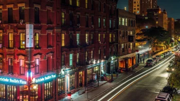 the lights of manhattan at night, with the facades of brick buildings, cars, automobiles, cities, city, cityscape, cityscapes, houses, buildings, new york, night lights, lights, streetlights, street lamps, lighting, night, roads, highways, motorways, avenues, driveways, passageways, streets, the city at night, usa, united states, architecture, world
