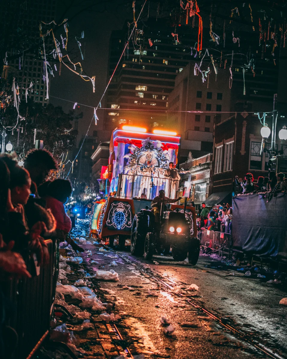 A vibrant Mardi Gras parade through the streets at night