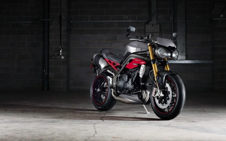A Triumph Speed Triple in the dim light of a concrete garage