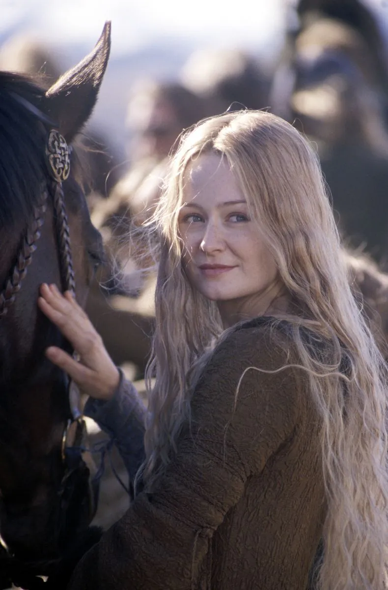 Éowyn strokes her horse in the morning sun