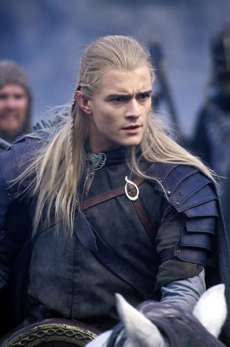 Legolas in armor, riding a horse before the battle